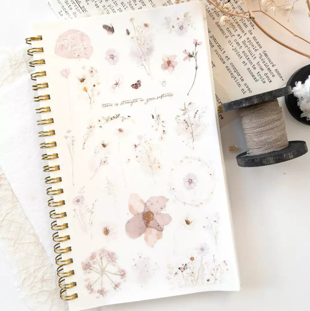 Spiral notebook decorated with Soft Days PET Tape floral stickers on a white surface