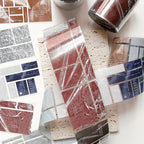 Decorative paper samples with text on a white surface