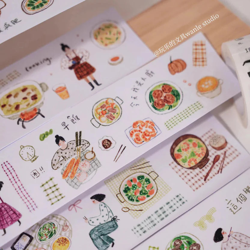 Sticker sheets with illustrations of food and people on a wooden surface.