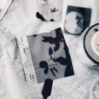Black and white patterned card on a textured surface