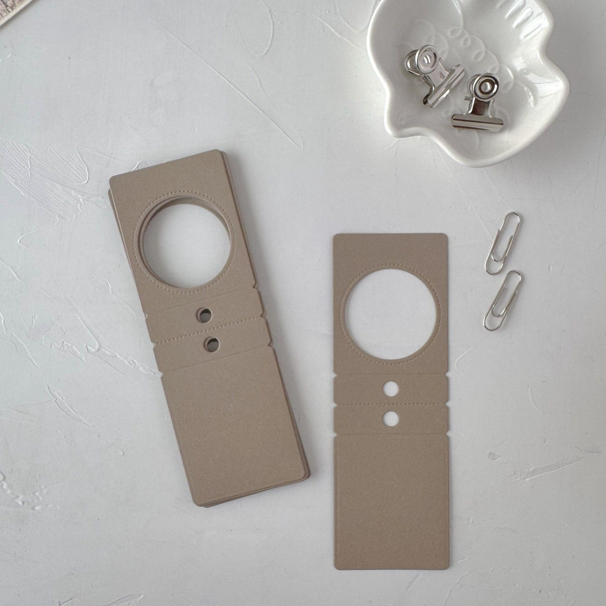 A pair of coffee Specimen Card Vol. 2 cards with paper clips on a light grey surface