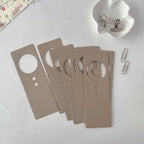 Set of brown door hangers on a light gray surface with clips.
