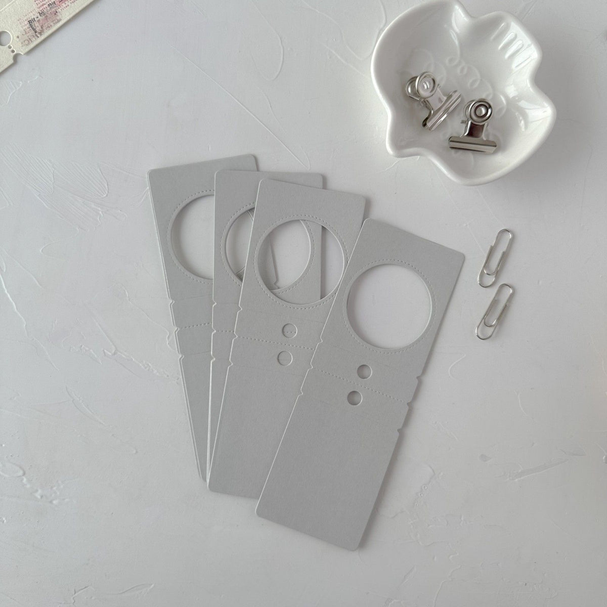 Grey Specimen Card Vol. 2 ephemera cards with circular cutouts on a light grey surface