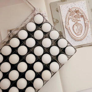 Tray of white Sponge Daubers for ink blending displayed on a light background, styled detail view