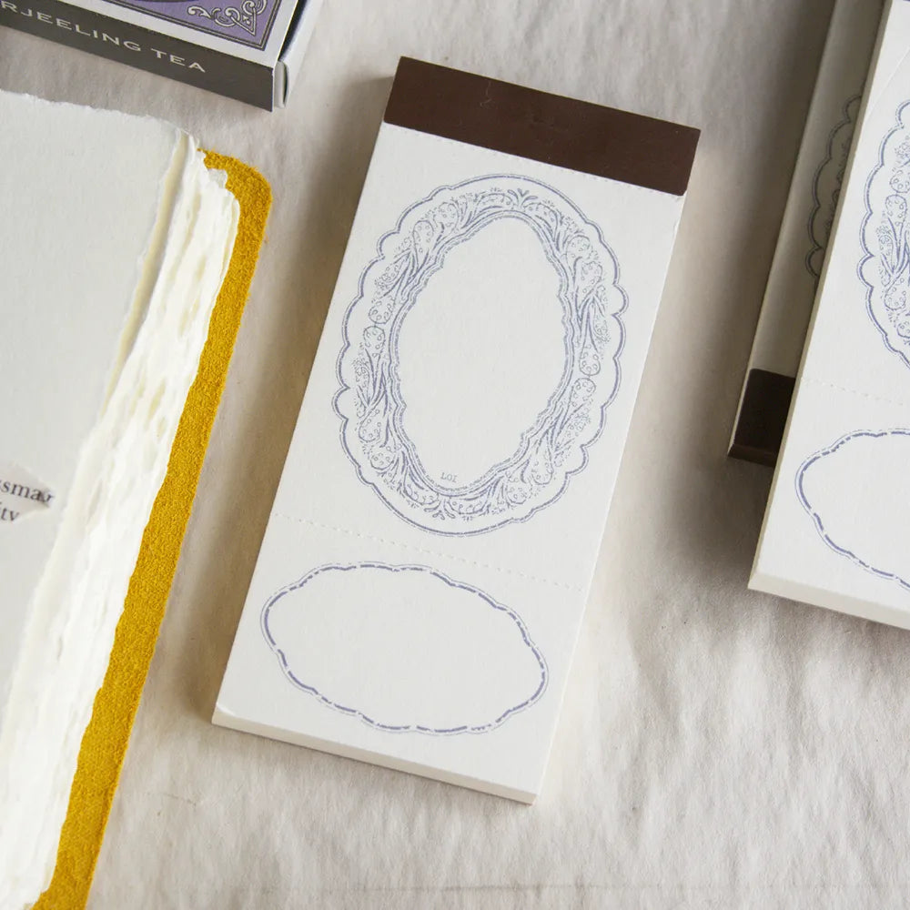 Spring Frame Purple Memo Pad by Loidesign with its decorative cover on a textured surface