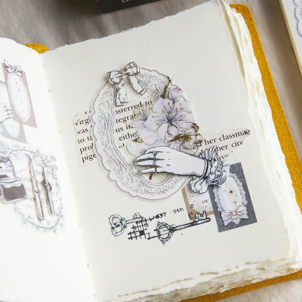Open book styled with Spring Frame Purple Memo Pad hand, key and flower illustrations