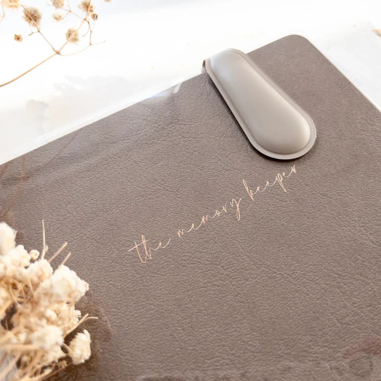 Spring Cottage Magnetic Bookmark on a grey Memory Keeper journal with dried flowers on white