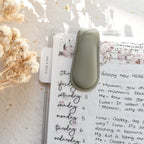 Small green device on a notebook with floral decorations
