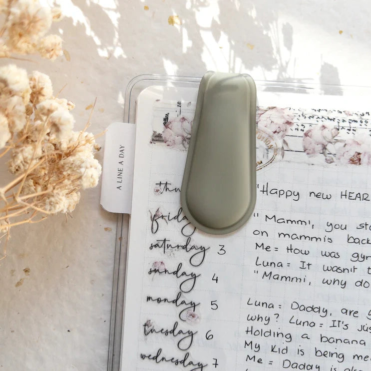Small green Spring Cottage Magnetic Bookmark clipped to a notebook with floral decorations