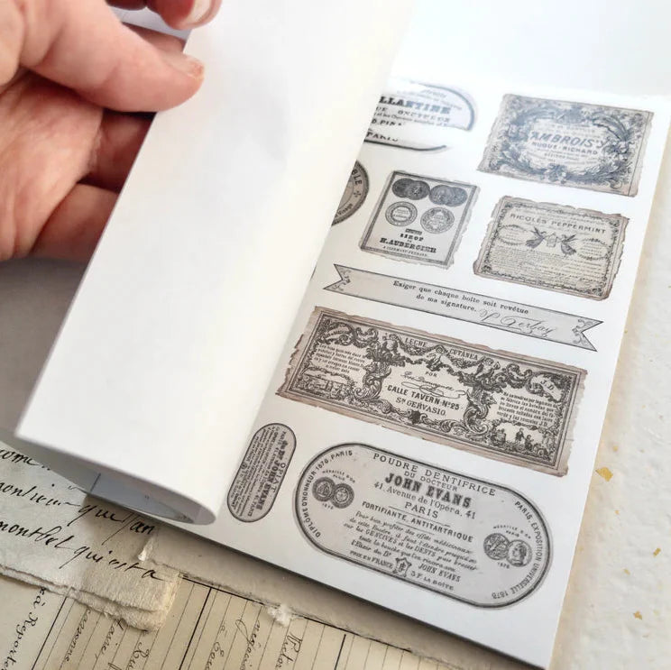 Spring Cottage sticker book page with vintage French label designs in neutral tones
