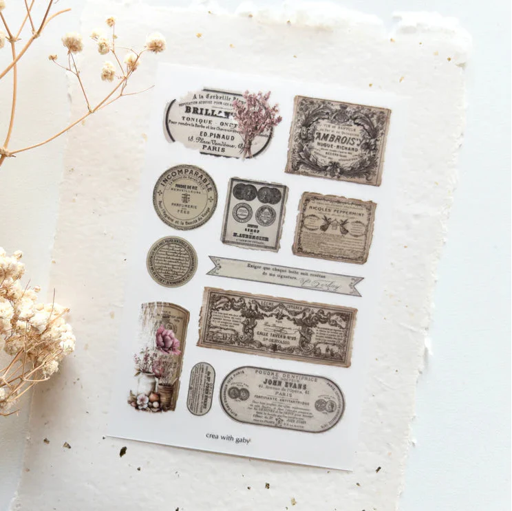 Spring Cottage Labels Transfer Sticker vintage product labels on a textured surface with flowers