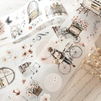 Collage of vintage-style illustrations including a bicycle, flowers, and architectural elements on a light background.