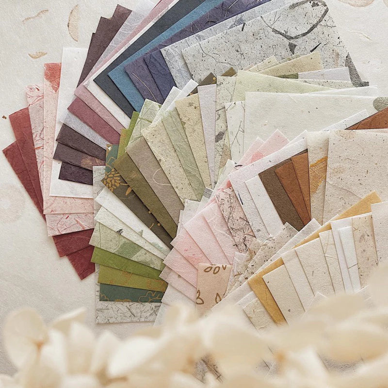 Collection of various textured paper samples in a fan arrangement.