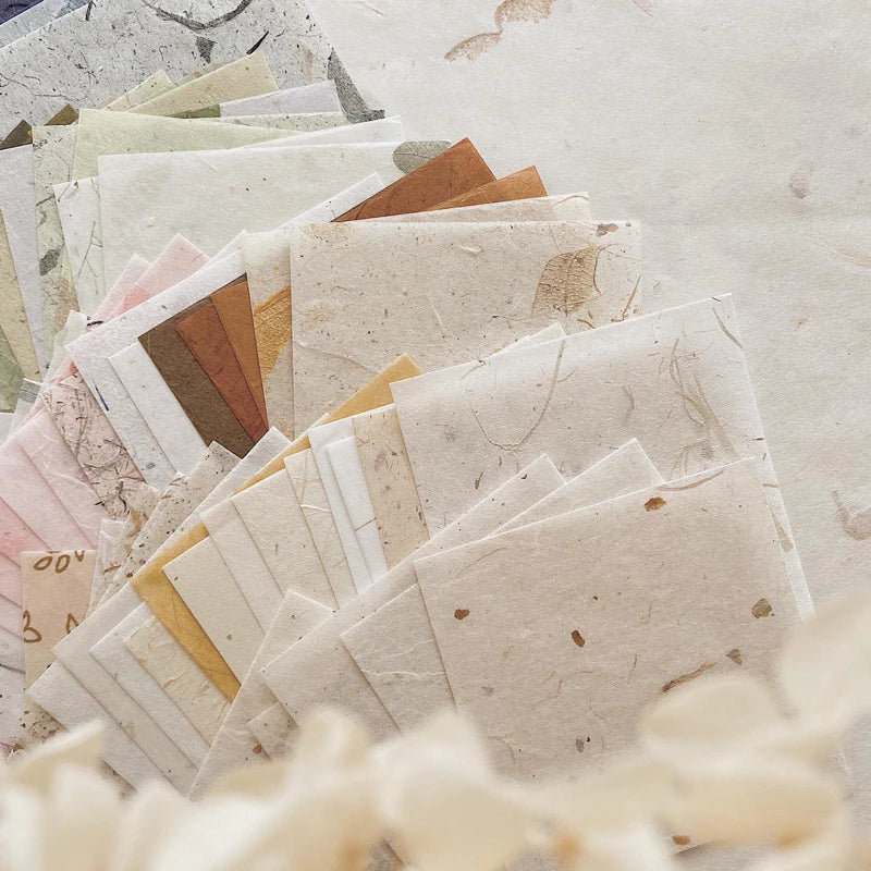 Square Paper Vol. 2 sheets in varied textures and colors on a neutral background