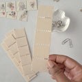 Beige fabric swatches with decorative elements on a light gray surface.
