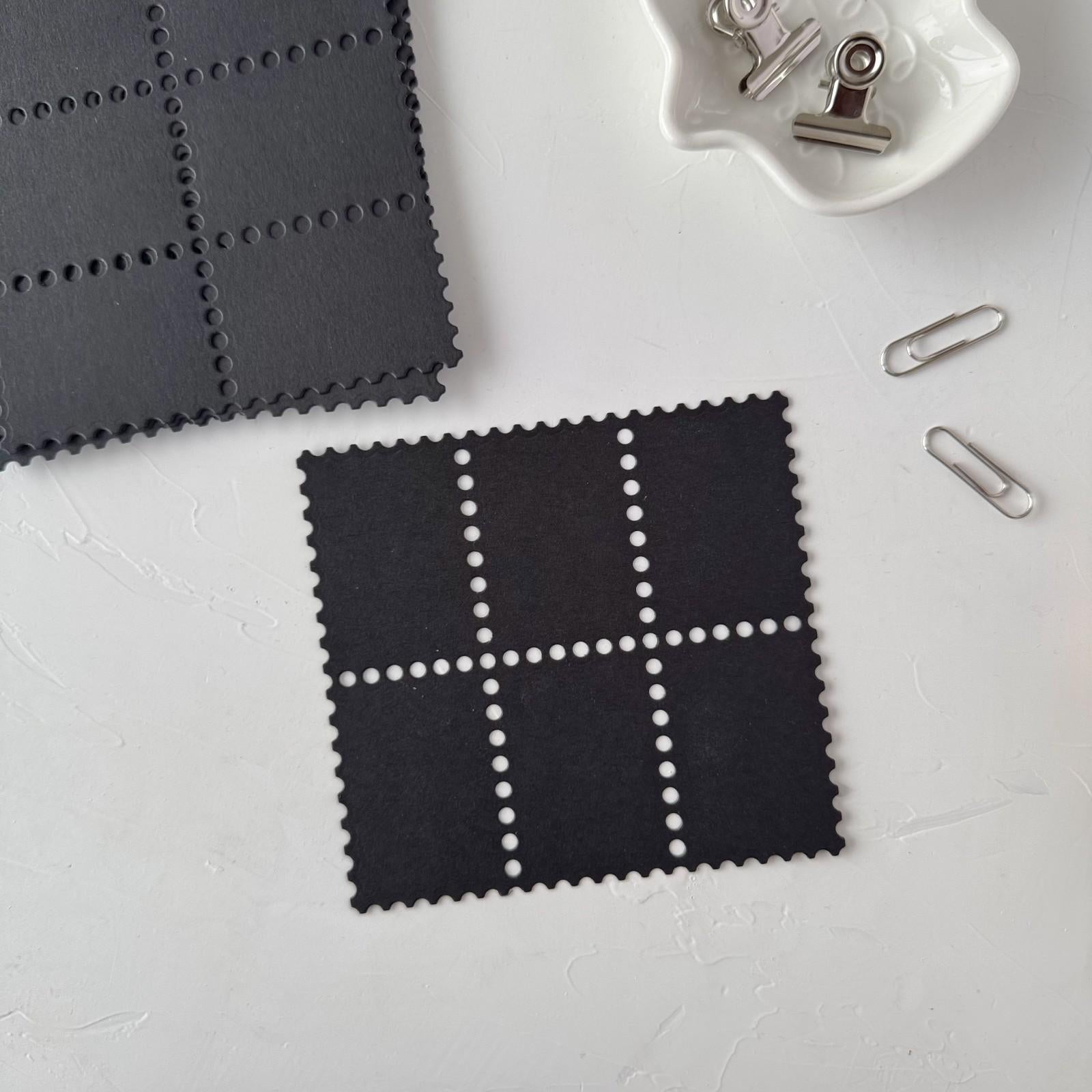 Black square fabric swatch with white grid pattern on a light gray background