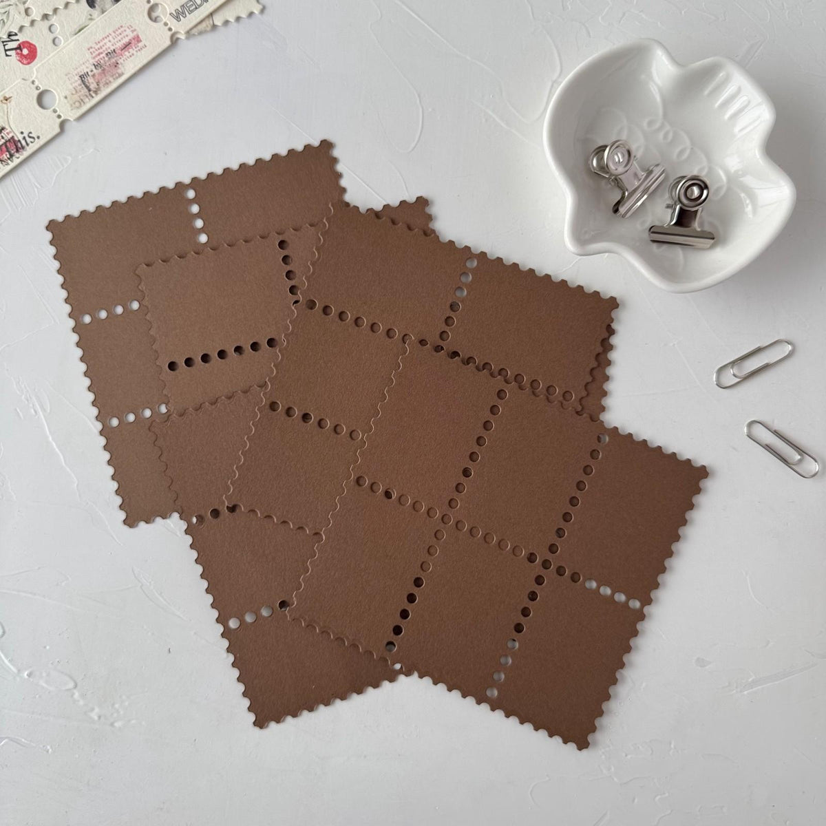Brown Stamp Card Vol. 3 perforated cards on white styled with small stationery clips