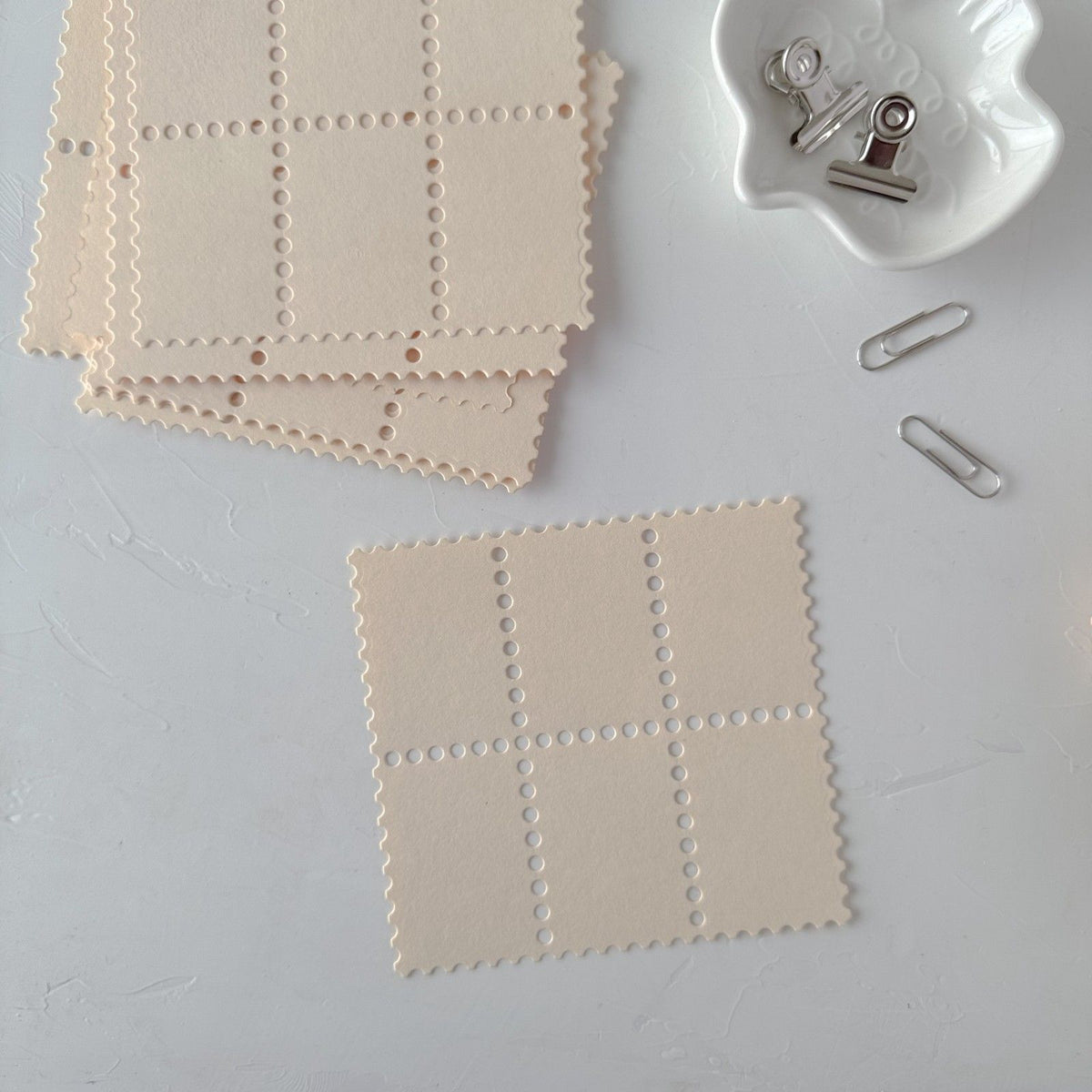 Cream Stamp Card Vol. 3 square cards with grid patterns displayed on a white surface
