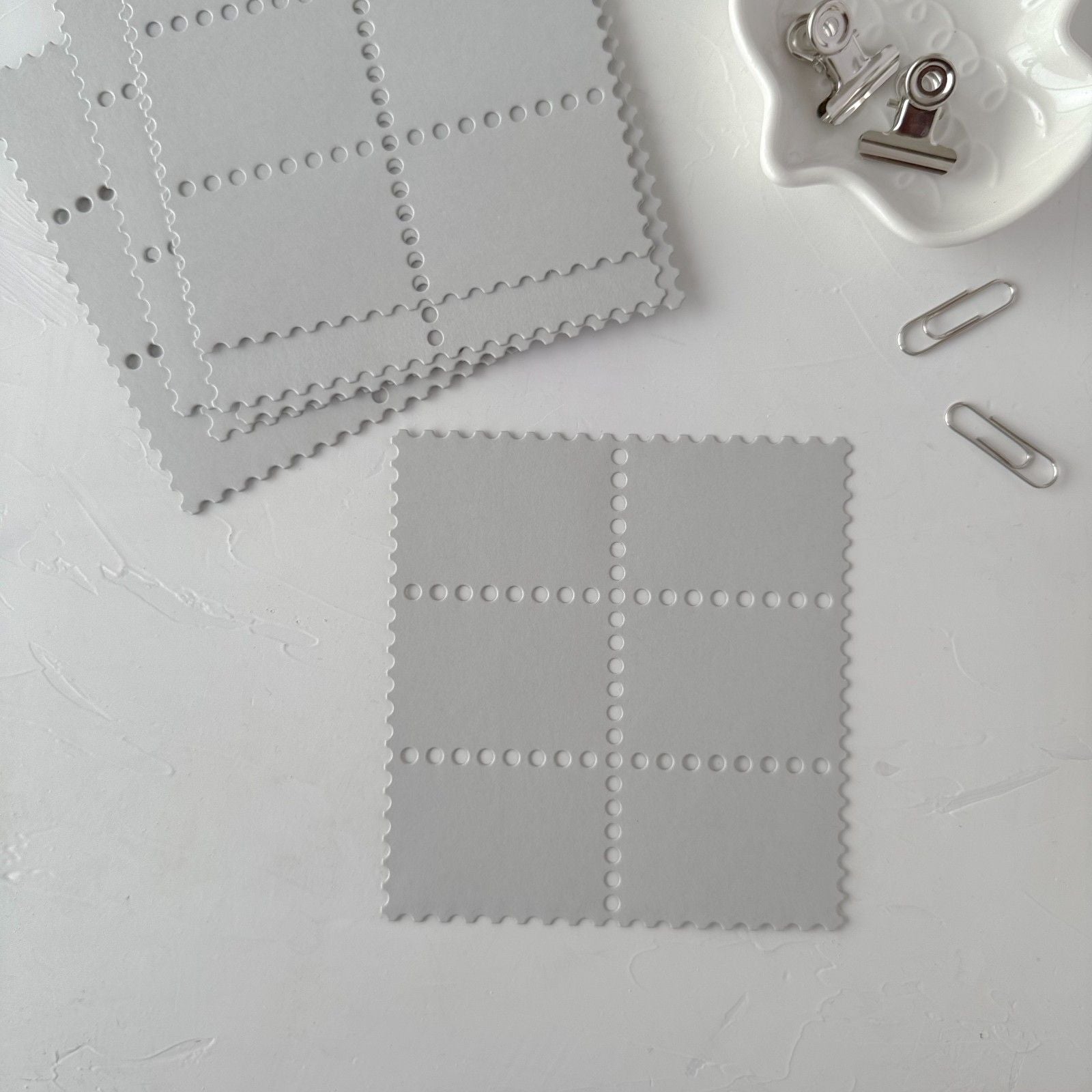 Grey Stamp Card Vol. 3 square cards with perforated stamp edges on a light grey backdrop