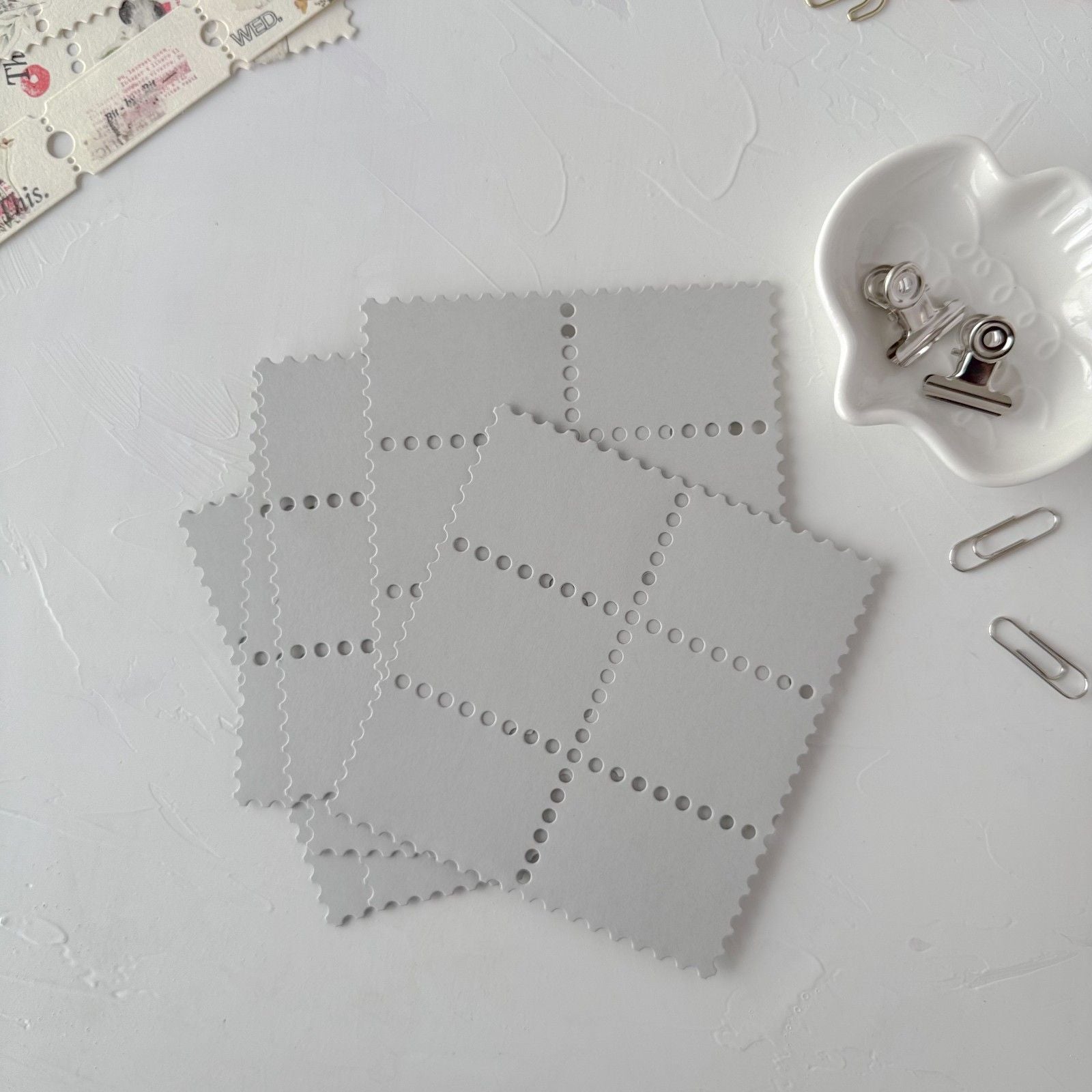 Grey Stamp Card Vol. 3 star-cutout cards styled with small clips on a light grey surface