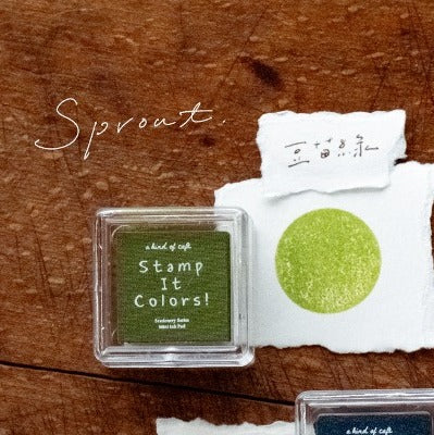 Sprout Stamp Ink Pad with its packaging and fresh green swatch on a warm wooden surface