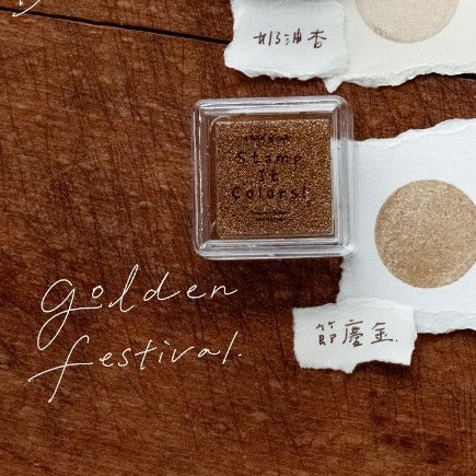 Cosmetic sample with 'golden festival' text on a wooden surface