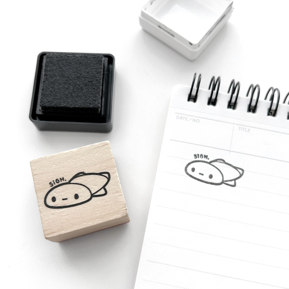 Sigh. Rubber Stamp by The Coffee Monsterz CO — cute doodle rubber stamp beside a notebook, for journaling
