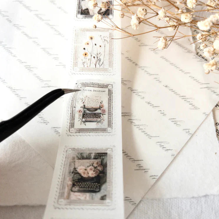 Decorative stamps with typewriter and floral designs on a white surface.