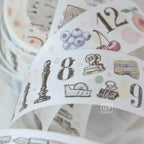 Roll of decorative tape with numbers and illustrations on a white background