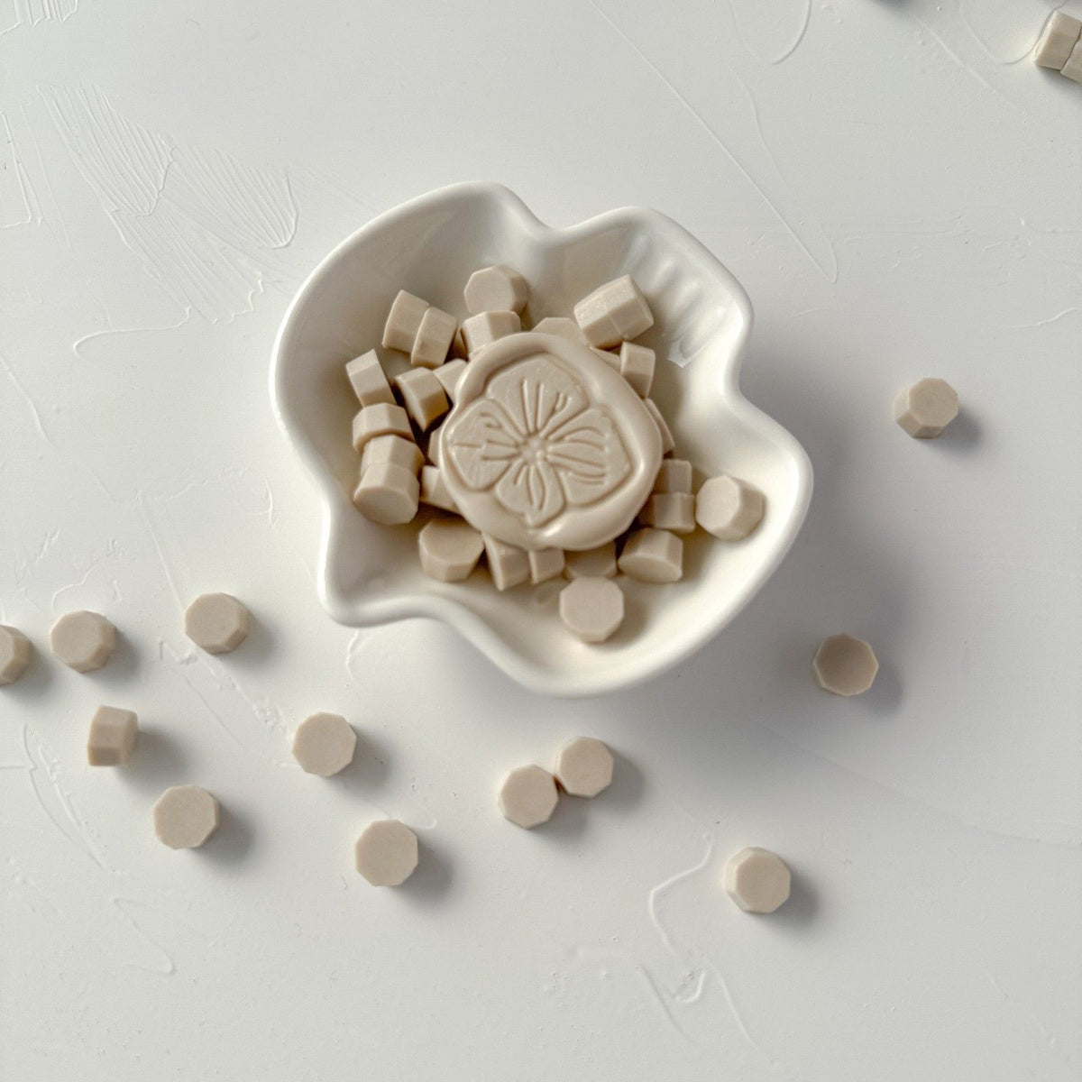 Steamed Milk Wax Beads in a creamy off-white shade styled in a white ceramic dish on a light grey backdrop