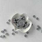 White heart-shaped dish with hexagonal objects on a light gray background