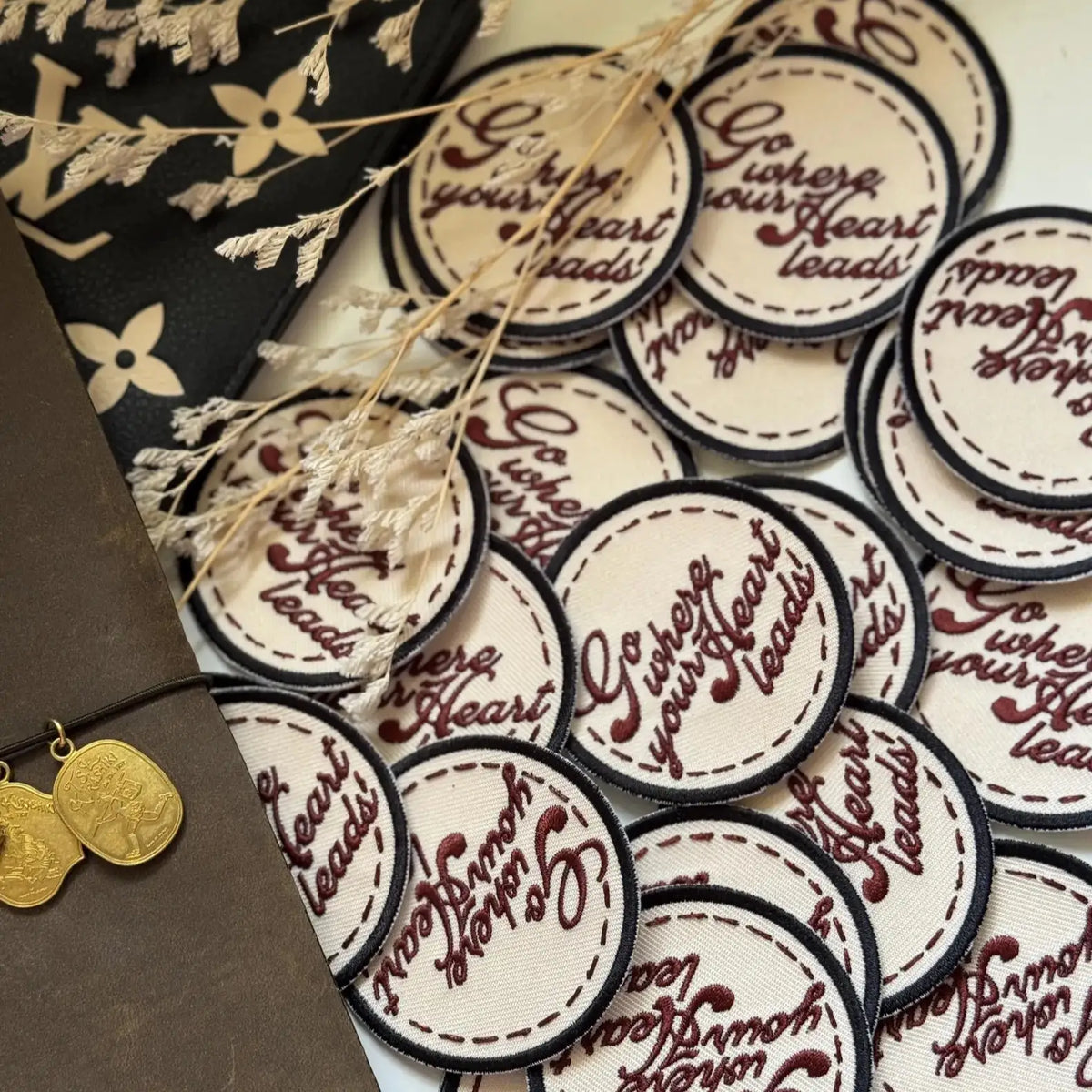 Circular Go Where Your Heart Leads Embroidered Patches arranged with decorative elements