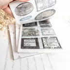 Roll of vintage-style labels with black text on a white background