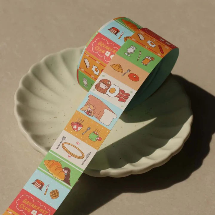 Breakfast Club Label Sticker Tape strip draped over a plate showing pancake and egg icons