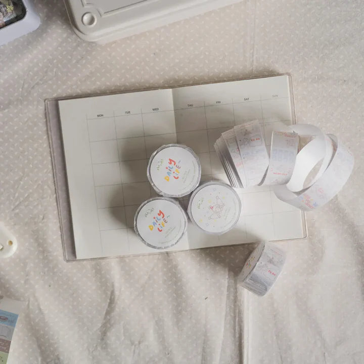 Monthly planner board with three Daily Life Label Sticker Tape rolls and loose strips