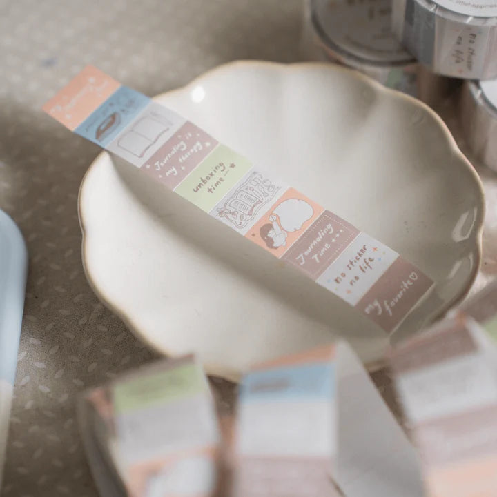 Strip of Stationery Lover Label Sticker Tape across a ceramic plate with text labels