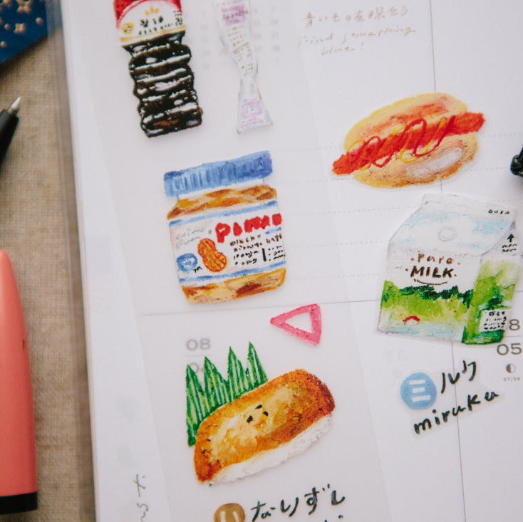 Convenience Store PET Tape food and stationery stickers applied across an open notebook page