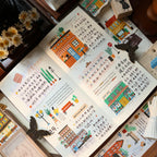 Open book with colorful illustrations and text on a wooden surface.