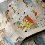 Illustrated cityscape with buildings and people on a book page