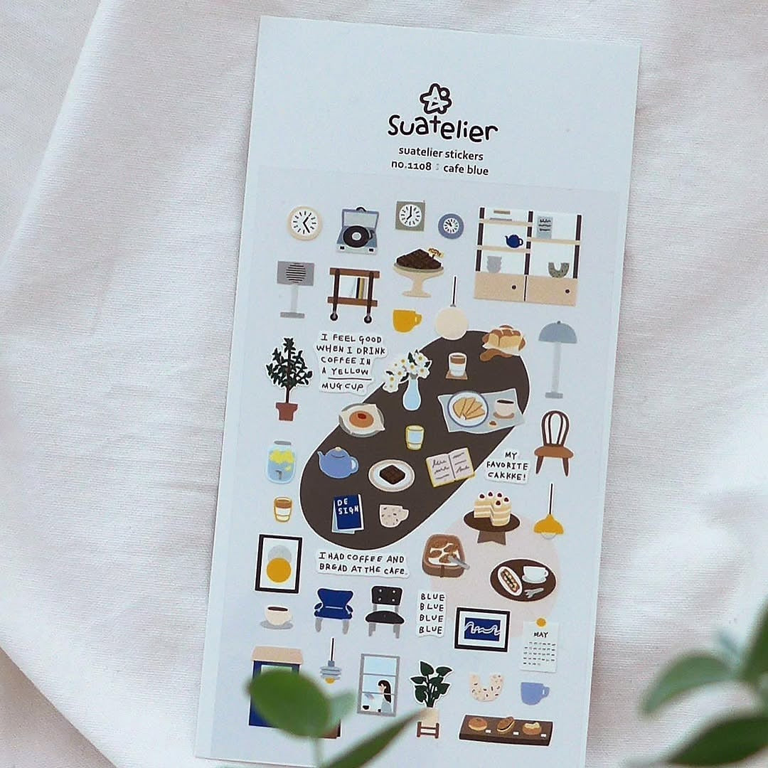 Sheet of decorative stickers with various illustrations on a white background, featuring the brand 'Suatelier'.