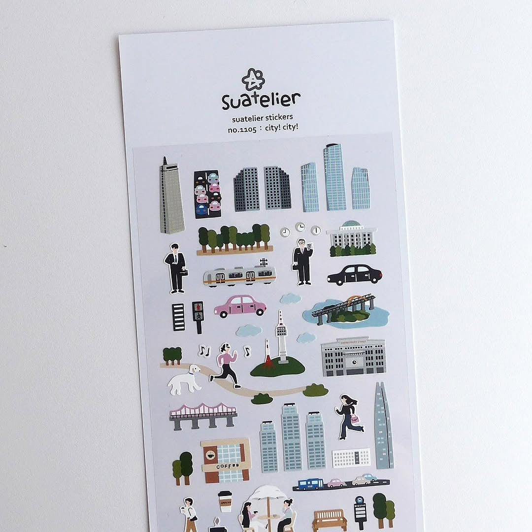 Sheet of city-themed stickers with Suatelier branding on a white background