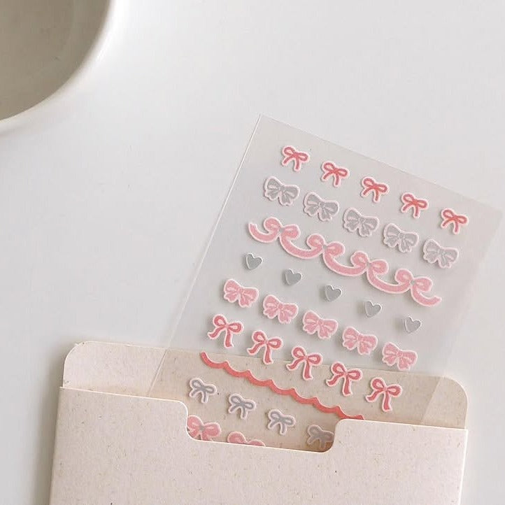 Sheet of decorative stickers with bows and hearts on a white surface, from the Deco 13 Sticker Sheet