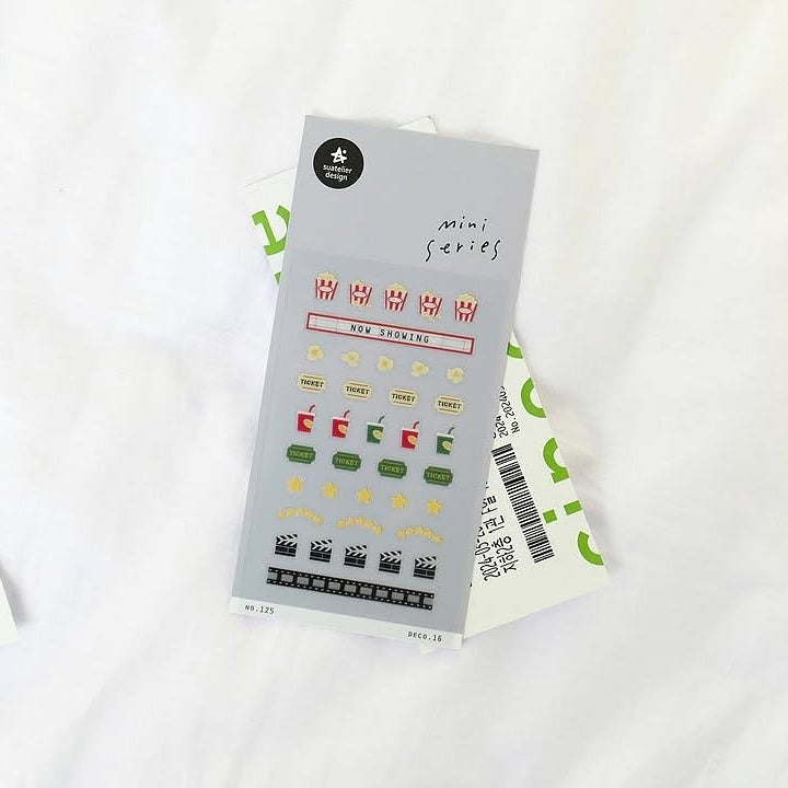 Deco 16 Sticker Sheet by Suatelier, stickers with movie-themed designs on a white background
