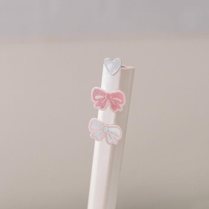 Two decorative clips with pink bows against a beige background, from the Deco 13 Sticker Sheet