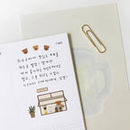 Notebook with stickers and a paper clip on a white background