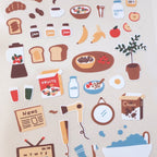 Collection of illustrated breakfast-themed stickers on a beige background