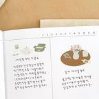 Open book with illustrations and text on a beige background
