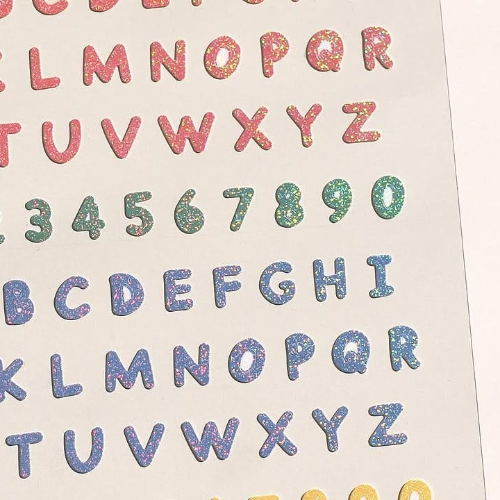 Colorful alphabet and number stickers on a beige background