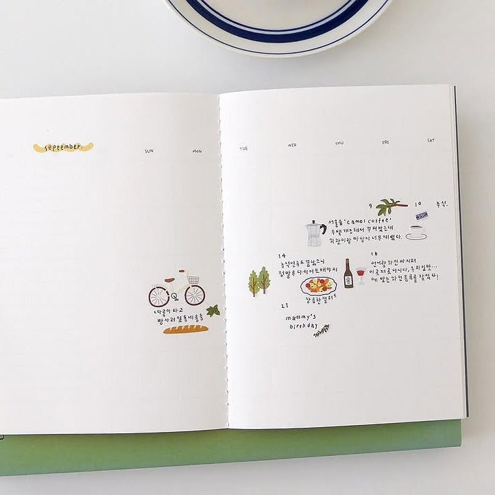 Open book with illustrations and text on a white surface, from the In The Garden Sticker Sheet
