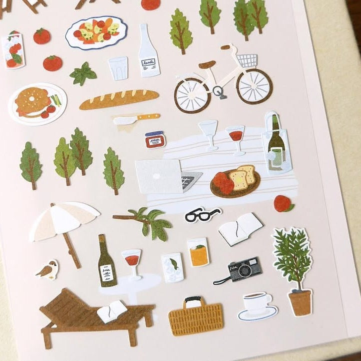 Illustrated stickers of food, travel and nature on a beige background, from the In The Garden Sticker Sheet